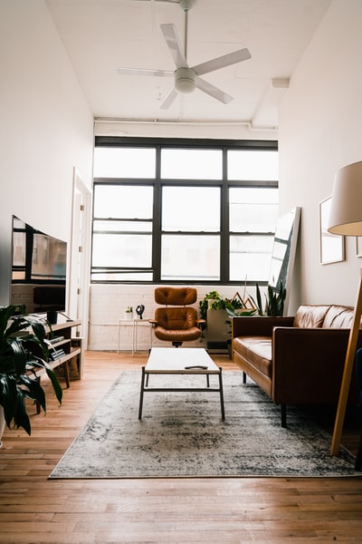 Brown wooden table by the window with a chair
